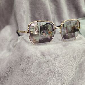 CHANEL Women's Glasses with Gold Frame and Black Accents